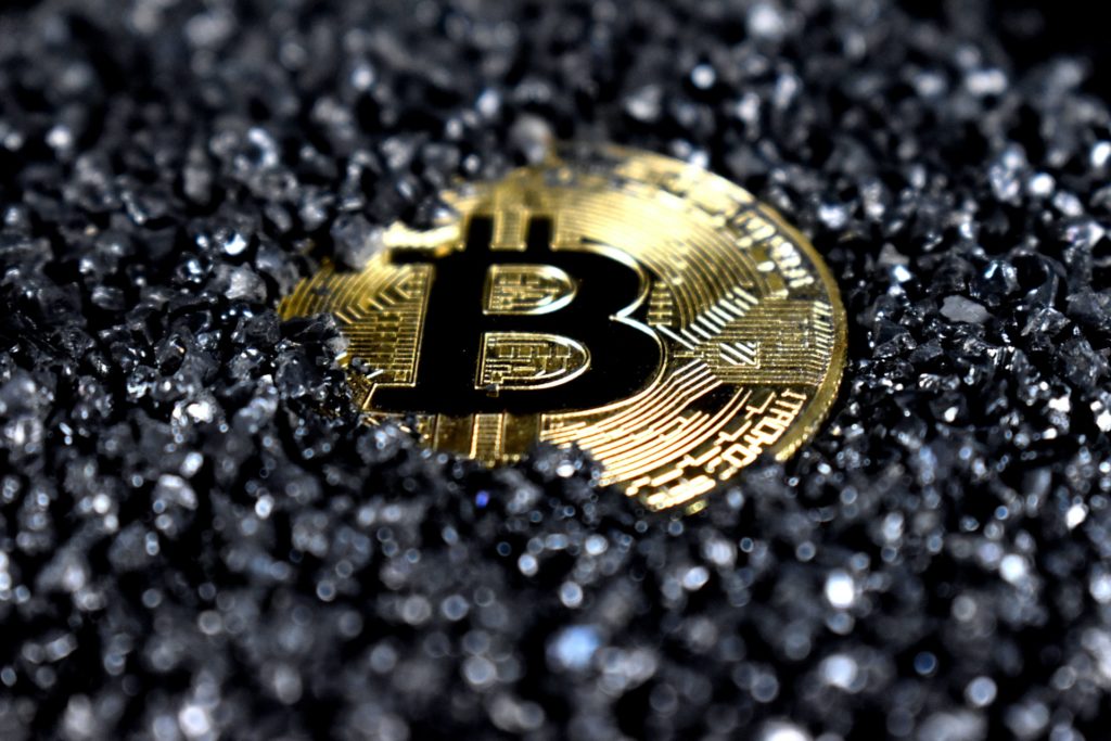 bitcoin covered in black crystals