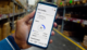 hand holding a phone using TUU app